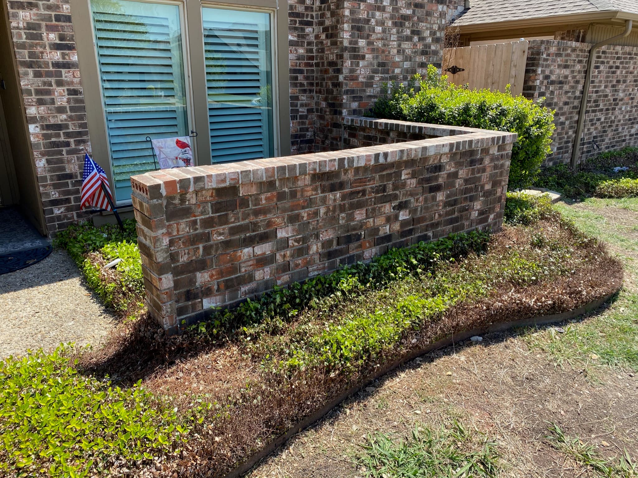 A detailed view of a home’s exterior wall featuring a combination of brick and stone masonry, highlighting texture and craftsmanship